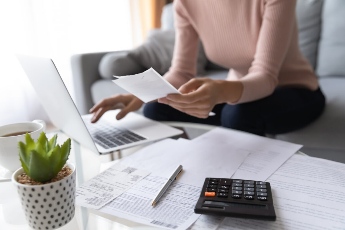 Crop,Close,Up,Of,Economical,Woman,Work,On,Laptop,At Woman sitting at laptop filing tax return