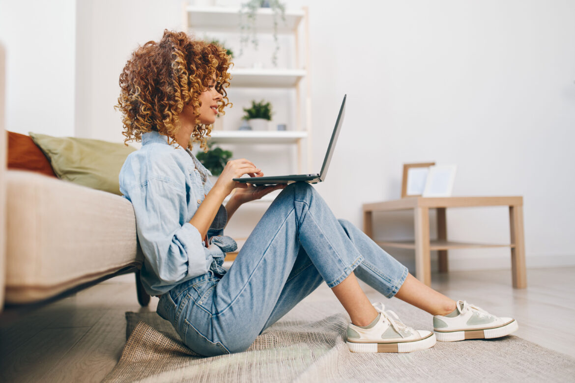 smiling-woman-typing-on-laptop-in-cozy-modern-liv-2025-03-10-23-06-16-utc