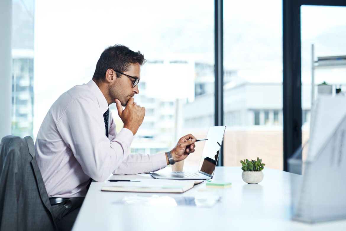 Professional investor working on a laptop at a desk, representing long-term investment strategy and portfolio planning for 2026