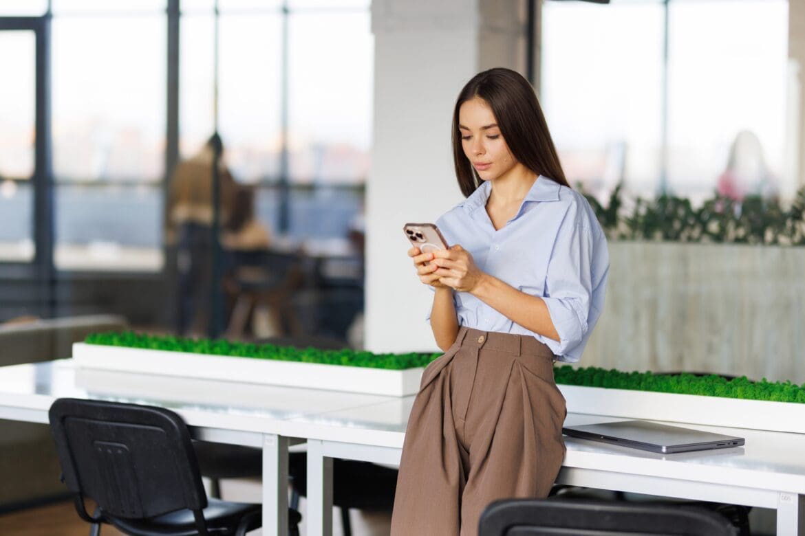 Woman reviewing investment markets on her phone while comparing value and growth stocks